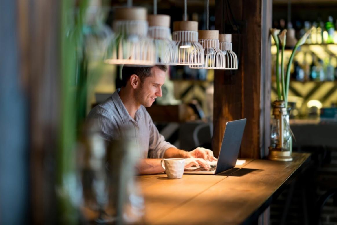 Estudiante analizando datos financieros en pantalla durante proyecto empresarial